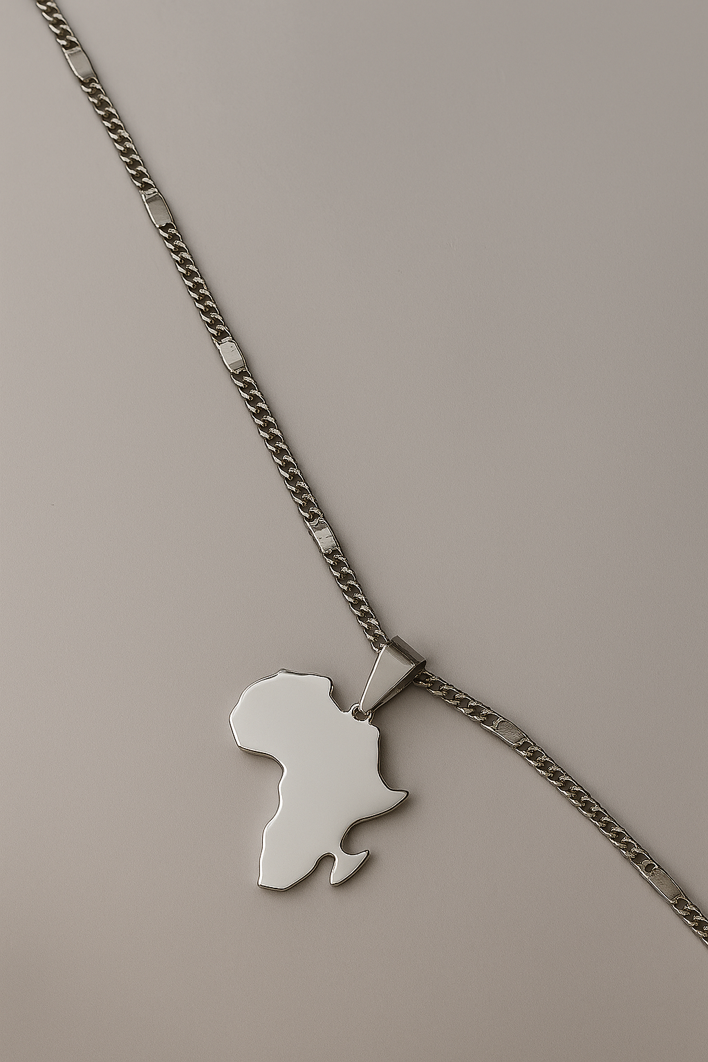 Necklace with a pendant shaped like a map of Africa on a beige background